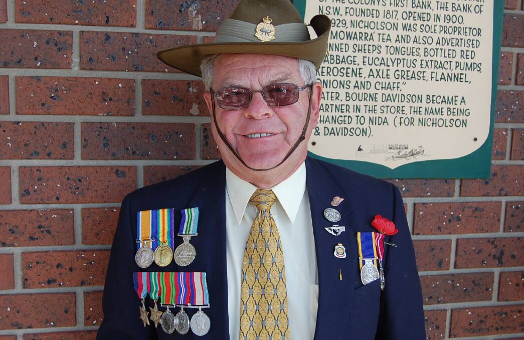 Former Army sergeant Eddy Evans prepares for the 2014 ANZAC Day march. Mr Evans is wearing his own medals, alongside those awarded to his grandfather for service in World War I, and his uncle's World War II medals.