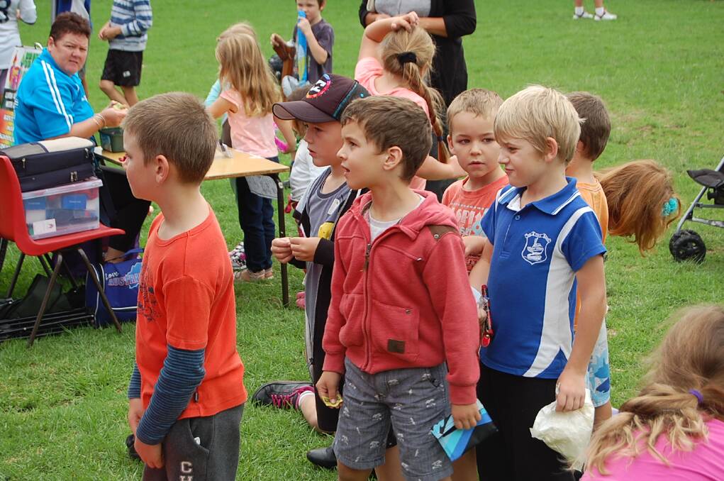 Standing in line for the jumping castle at the Eden Public School fete on Wednesday.