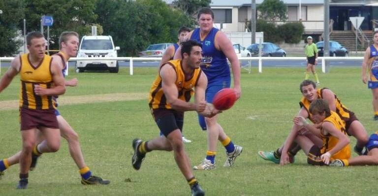 Panther Kyle Overend handballs to a teammate during the undefeated side's 100-point thumping of Bermagui on Saturday.