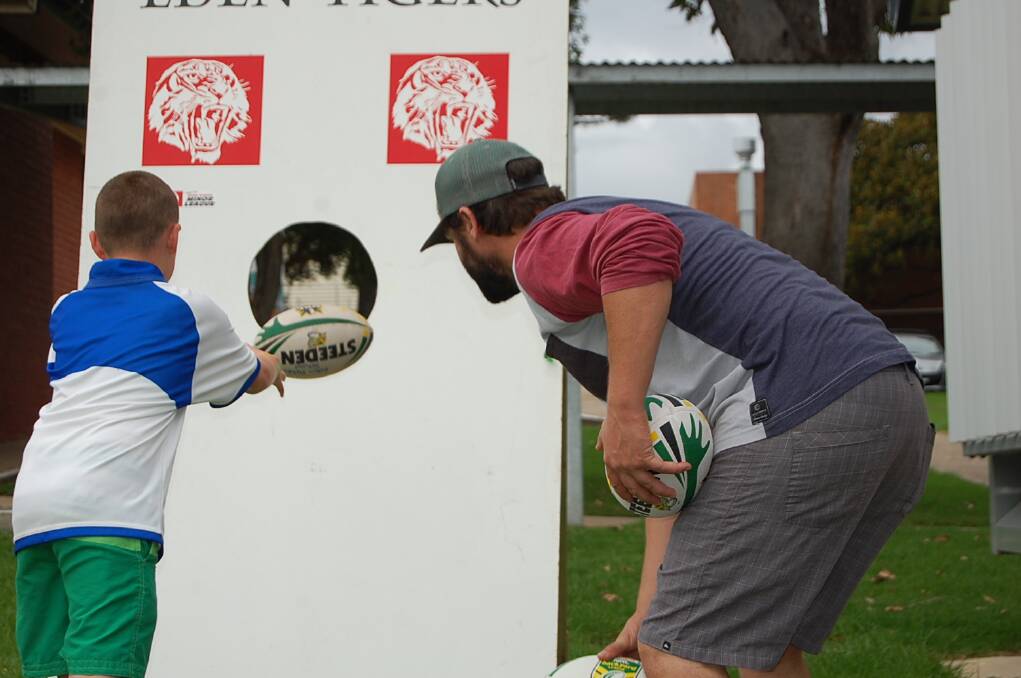 Todd Bolton cast a watchful eye over the pass-the-ball challenge at the Eden Public School fete on Wednesday.