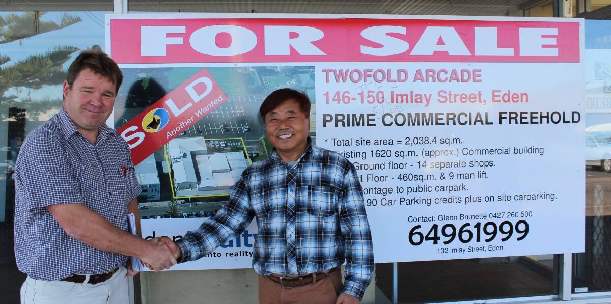 The new owner of Twofold Arcade, Benjamin Choi (right), is congratulated by selling agent Glenn Brunette, of Eden Realty.