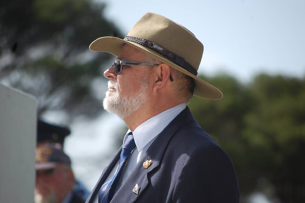 Eden RSL sub-branch secretary Steve Mahoney observes the ANZAC Day 11am service at the Eden cenotaph.