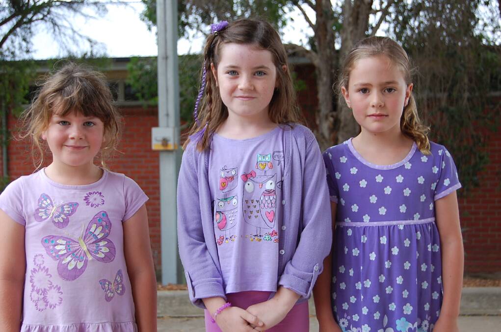 Ava Epe, Darcy Swane and Maggie Richardson made their statement by wearing purple to school on Wednesday.