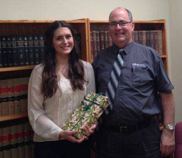 Eden Marine High School student Ellen Soroka receives the Sautelle White Lawyers Award for Excellence in Legal Studies 2014 from Merimbula solicitor Hugo White last month. Ellen received an ATAR of 95.9 in the 2014 HSC. Photo: Supplied.