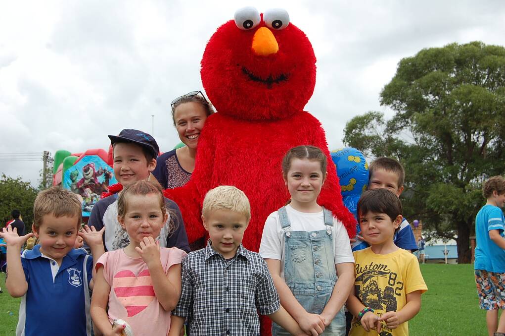 Elmo was the centre of attention for (front, from left) Luke Fraser, Ellie Chester, Mason Seymour, Darcy Swane and Patrick Swane, and (back, from left) Joseph Wilson, teacher Emma Bolton and Nathan McMahon at the Eden Public School fete on Wednesday.