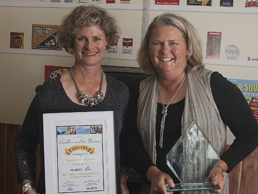 Lisa Newling and Loraine Lambert accept the 'best trades or professional services business or individual' trophy on behalf of the Sapphire Coast Golf School.