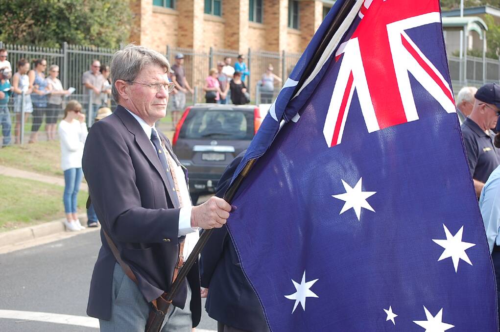 Richard Lamacraft proudly displays the Australian flag at the ANZAC Day 11am service at the Eden cenotaph.