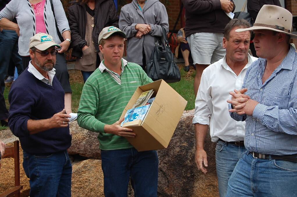 A box of books goes under the hammer at the 2014 Genoa Auction.