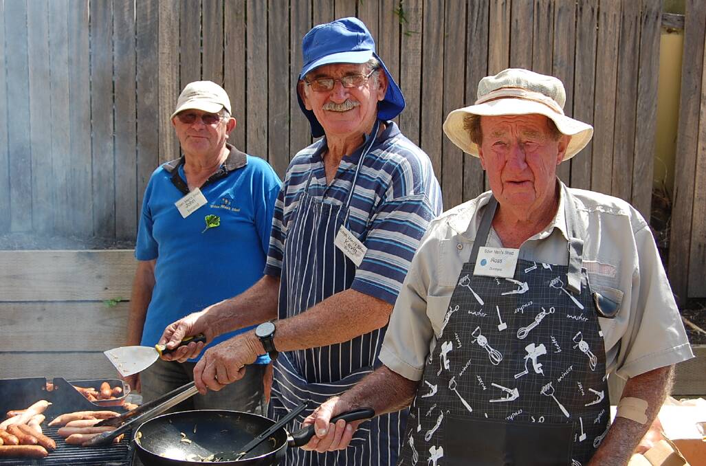 Those in attendance enjoyed a barbecue lunch thanks to (from left) John Ireland, Kevin Bryant and Ross Dobbyns.