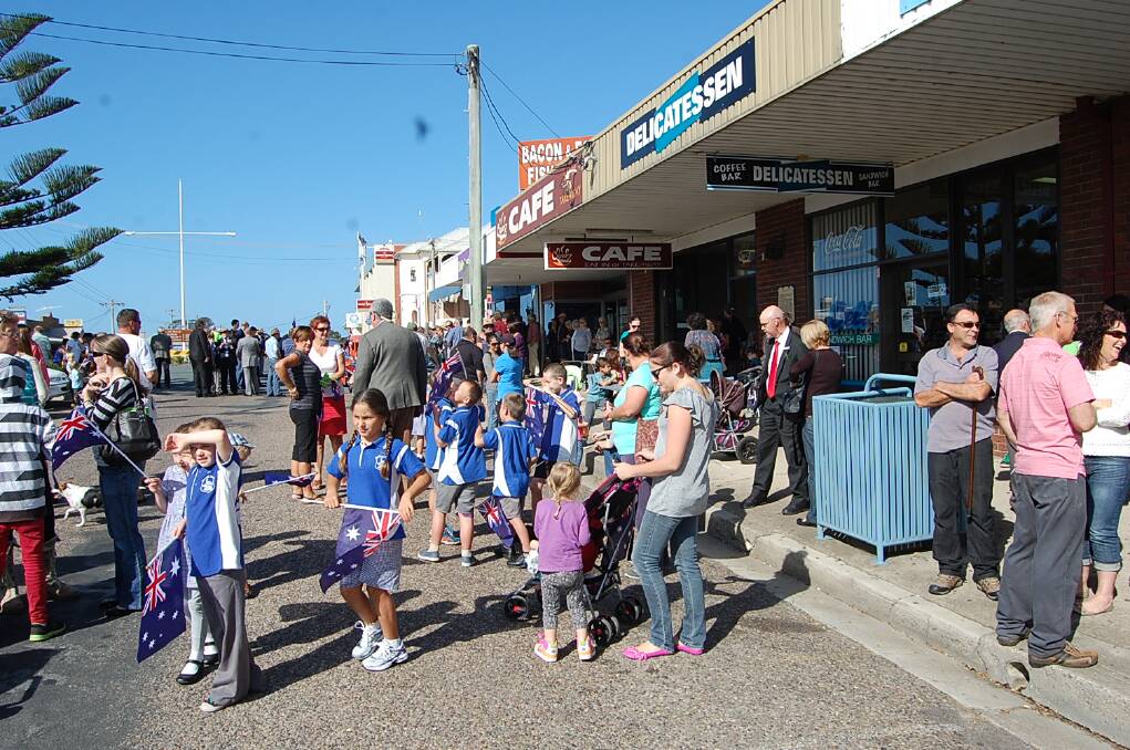 Crowds begin to gather on Imlay Street for the 2014 ANZAC Day march through Eden.