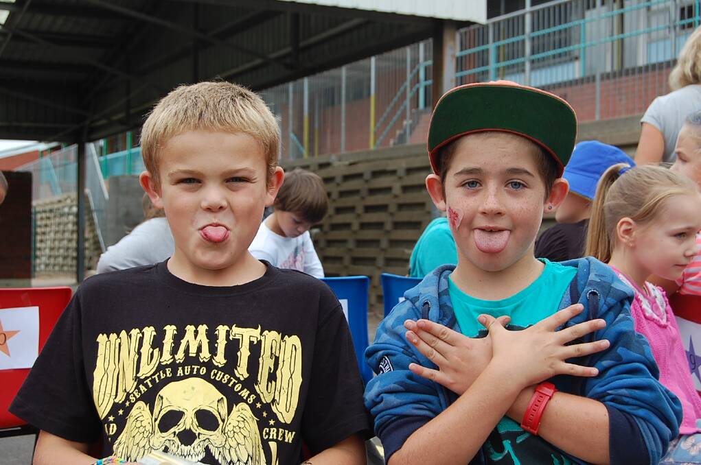 Jayden Rogers (left) and Luke Bruncic couldn’t wait to pose for the camera at the Eden Public School fete on Wednesday.