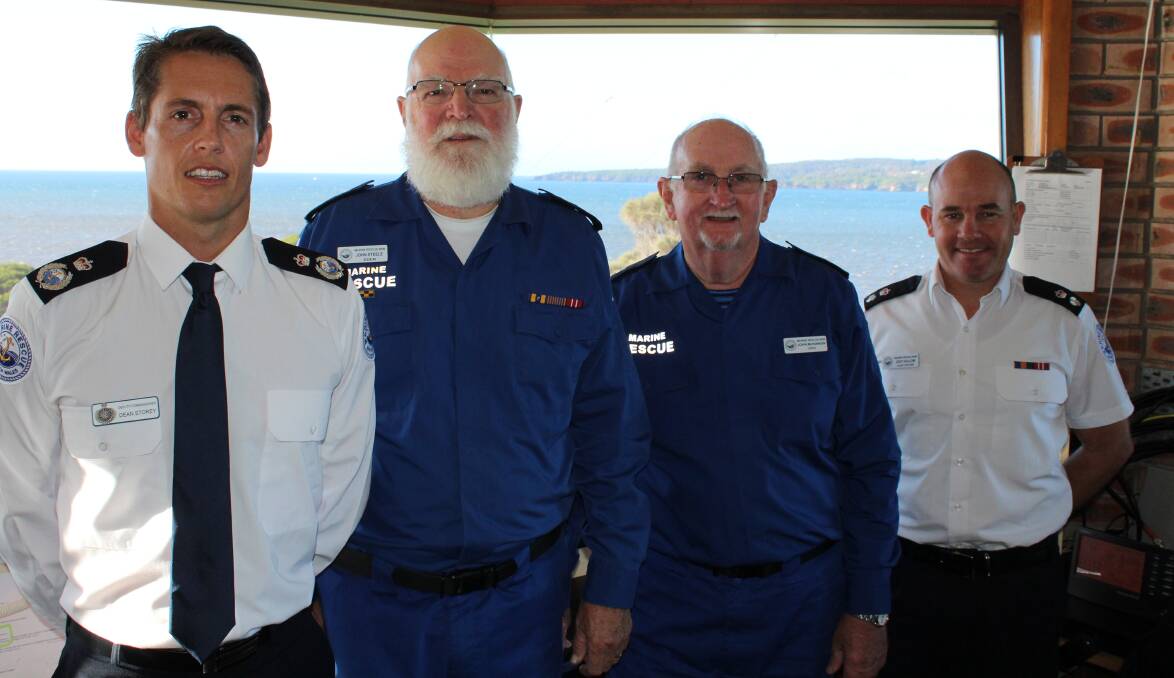 Marine Rescue NSW deputy commissioner Dean Storey (left) and fleet officer Jody Hollow (right) visited Marine Rescue Eden volunteers including outgoing unit commander John Steele, and his successor John McKinnon, on Tuesday morning.