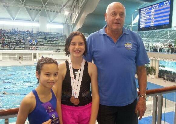 Swimming stars Sarah Davies, Georgia Caldwell and swim coach John Pelling.