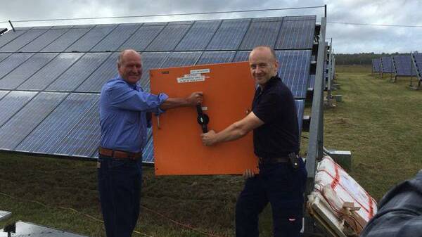Tony Windsor helps Andrew Thaler of Nimmitabel switch the Singleton Solar Farm back on.