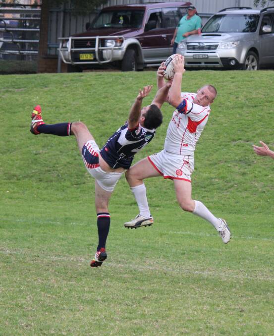 • Eden Tiger Ian Smith flies high over his Bega Roosters opponent to take a catch and score right on the try-line on Sunday.