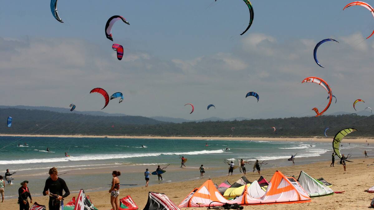 • The sky over Merimbula’s Main Beach is awash with colour as the kite surfers take to the water during last year’s Merimbula Classic. 