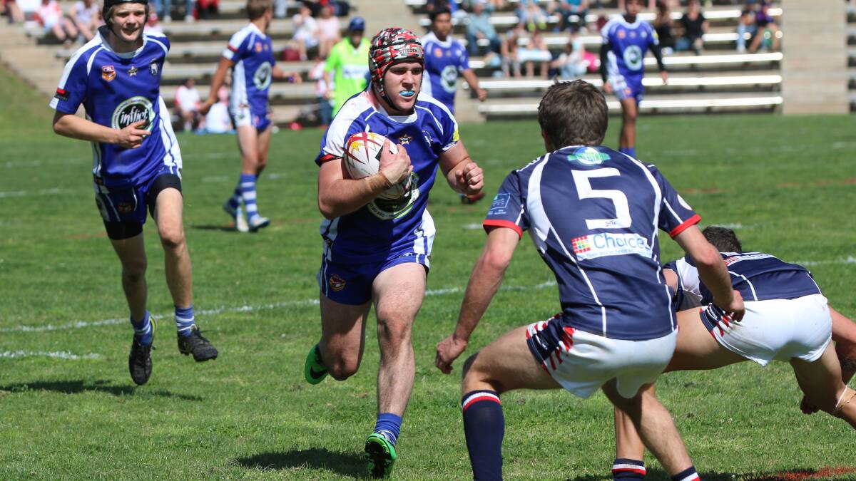 • Bulldog Kurt Lomas charges headlong at the Roosters’ defence during the Group 16 under 18s grand final in Bega on Sunday.