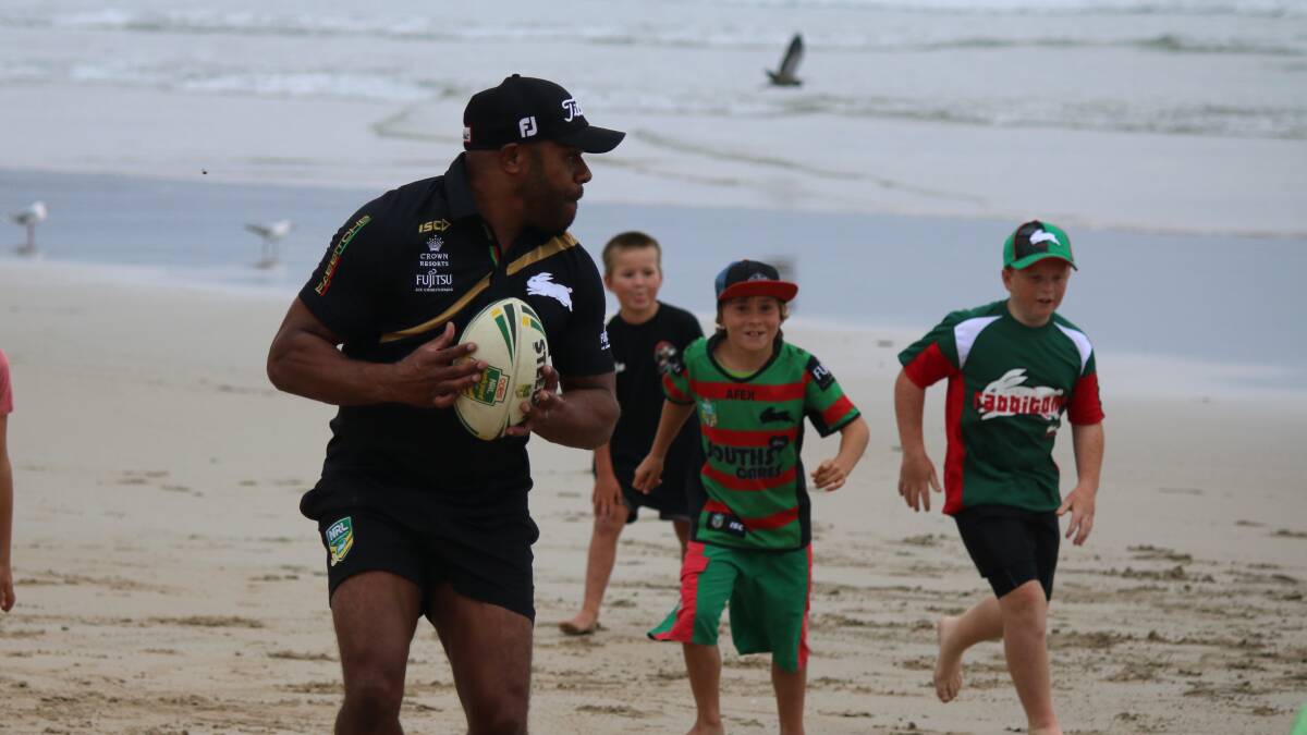 • Former Rabbitohs player Rhys Wesser takes part in an impromptu game of touch football with some young supporters on Monday. 