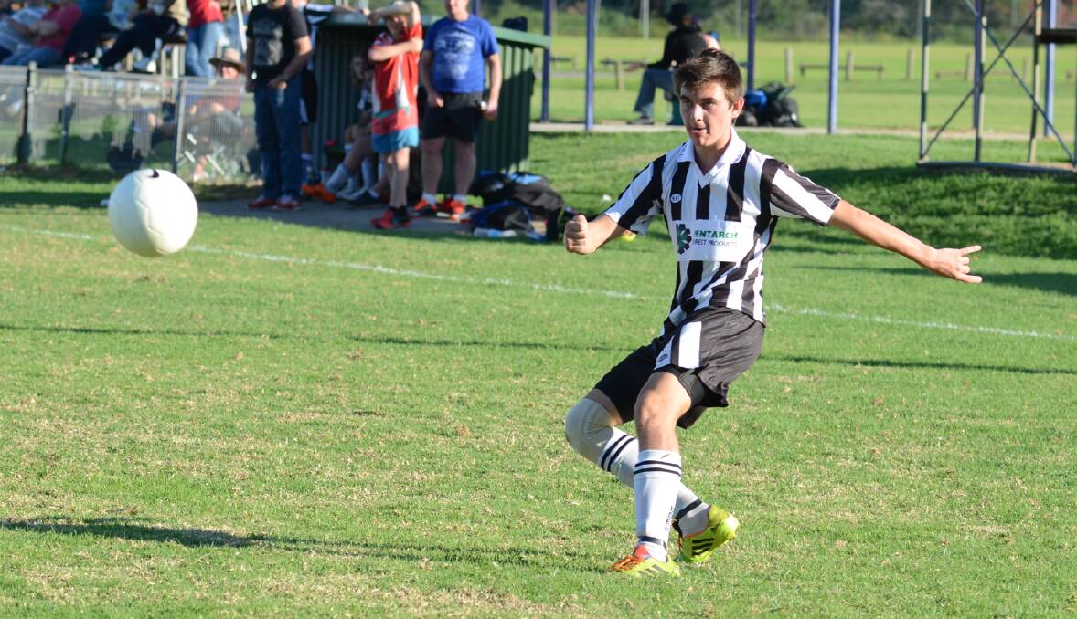 • Eden under 16s player Sam Williams makes a strong cross for his strikers against the Merimbula Grasshoppers. 