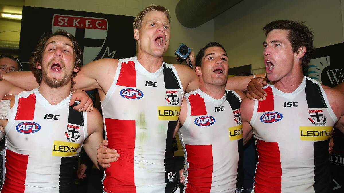 Josh Saunders, Nick Riewoldt, Leigh Montagna and Lenny Hayes of the Saints sing the song in the rooms after winning the round five AFL match between the Essendon Bombers and the St Kilda Saints at Etihad Stadium on April 19, 2014 in Melbourne, Australia. Photo: Quinn Rooney/Getty Images.