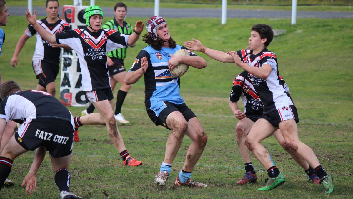BREAKING TACKLES: A mob of Cooma Colts players try to bring down Moruya Shark Cohen McGrath. 