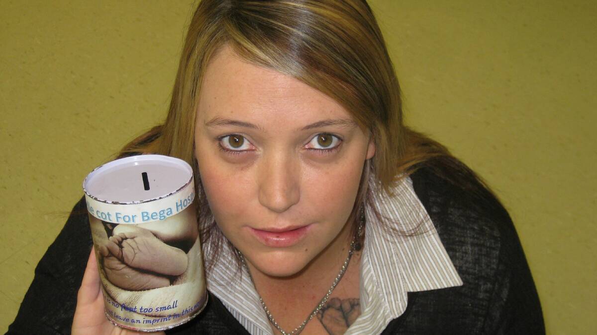 Tegan Goodyer holds a donation tin which features baby Jaxon's footprints. 
