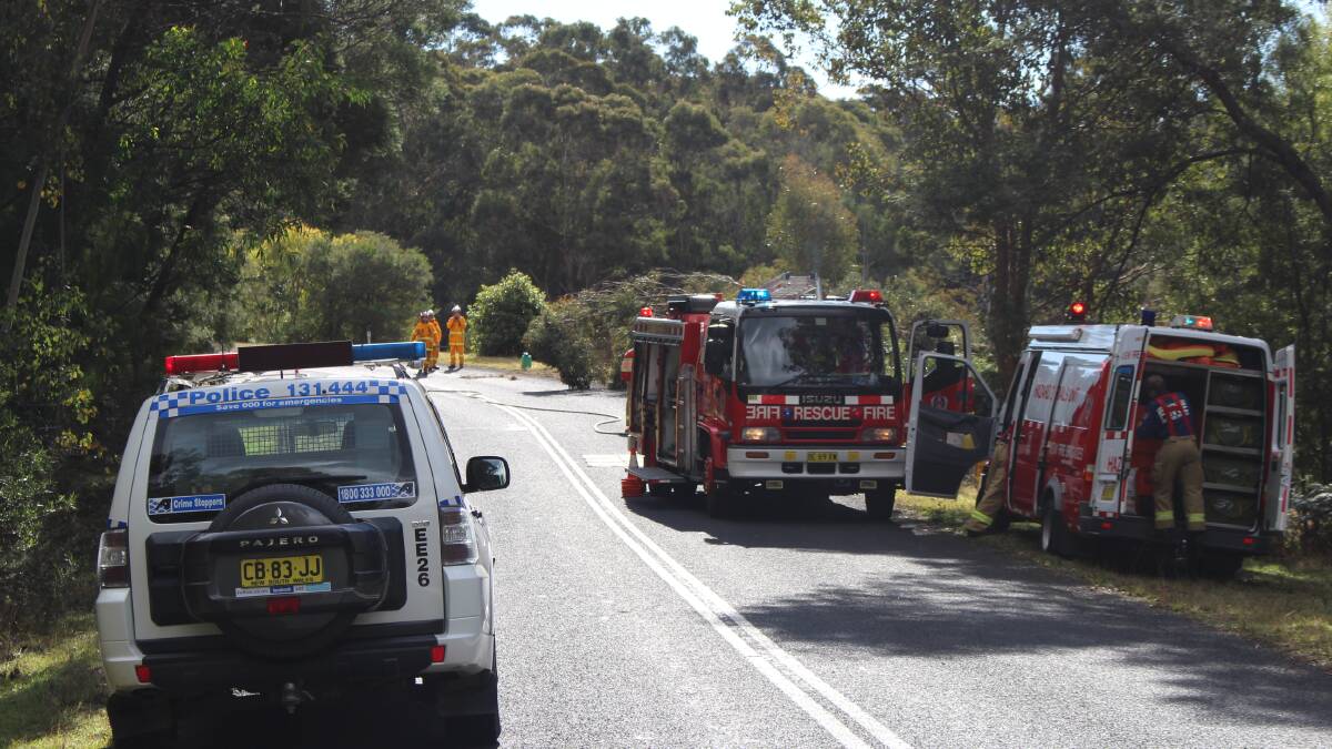 Police and emergency services attend the accident at Mount Darragh Road on Sunday. 