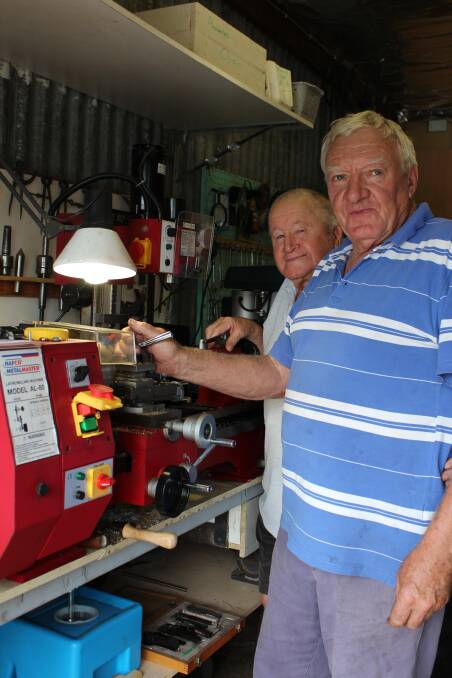 Ian English (front) using the lathe, with John Bowles (back) watching on. Photo Sandy Huff