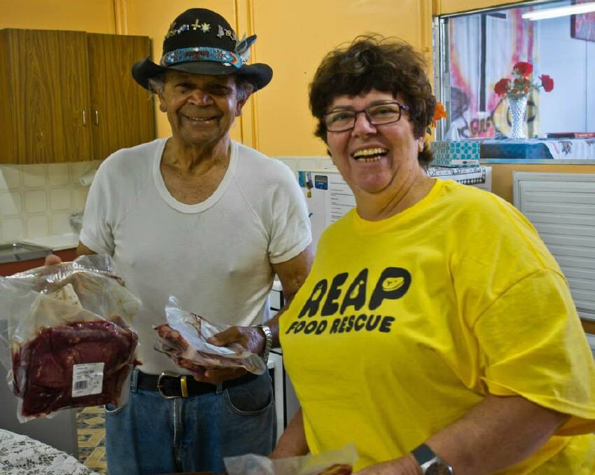 Christine Welsh, Sapphire Coast REAP Coordinator, delivering food to Pastor Ossie Cruse for distribution to those in need. 
