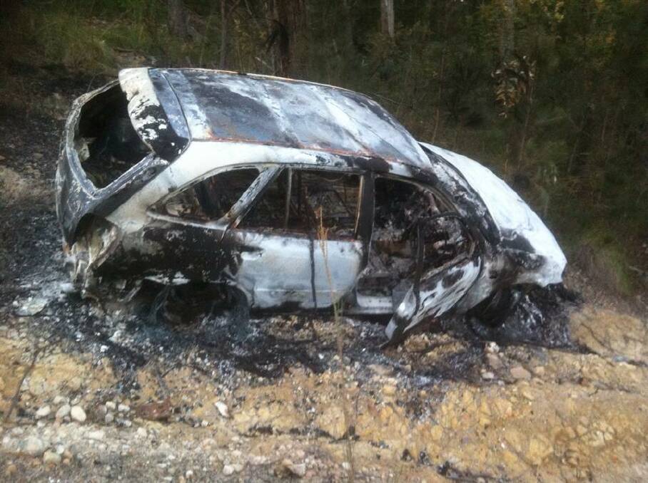 The burnt out remains of a stolen Mazda hatchback, dumped in bushland near the Eden water towers. 