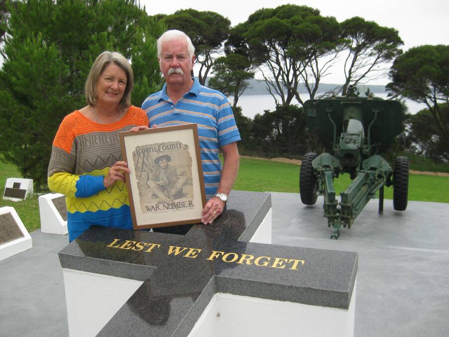 Gail and Dave Ward hold the framed recruitment poster of Gail's great uncle, John "Jack" Squire Armstrong. 