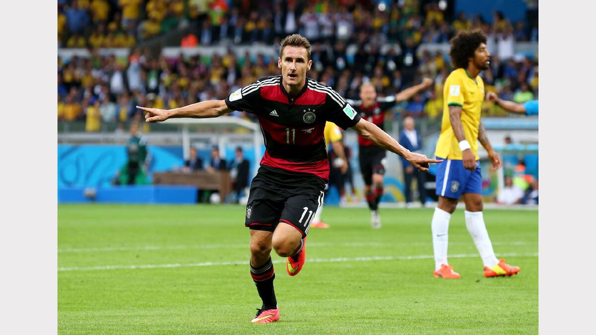 Miroslav Klose of Germany celebrates scoring his team's second goal during the 2014 FIFA World Cup Brazil Semi Final match between Brazil and Germany at Estadio Mineirao on July 8, 2014 in Belo Horizonte, Brazil.  (Photo by Robert Cianflone/Getty Images)	
