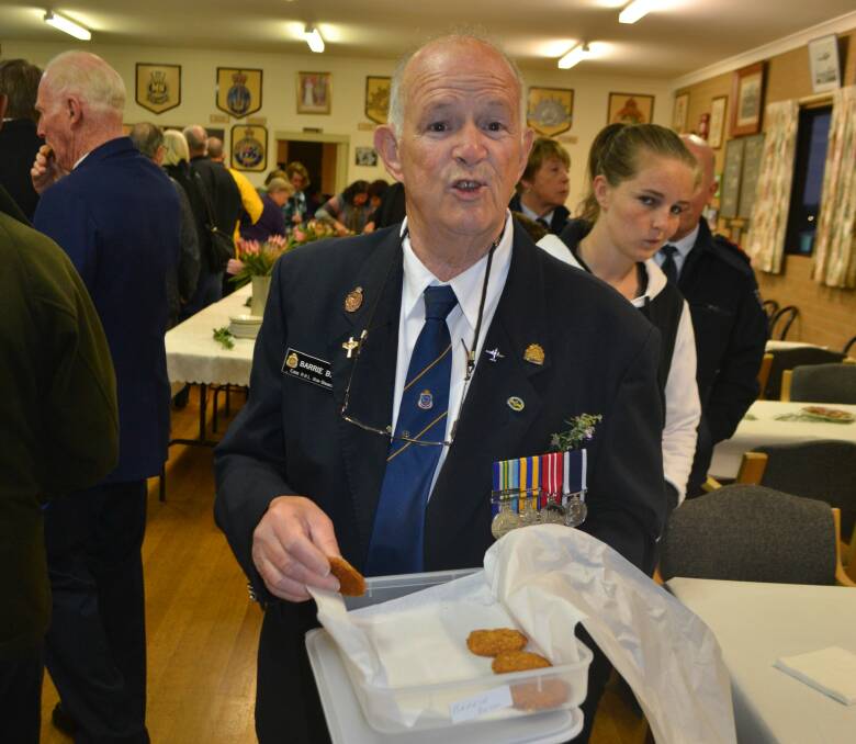 ANZAC Day 2014: Dawn service, Eden, NSW. Barrie Beck offers his home-baked ANZAC cookies.