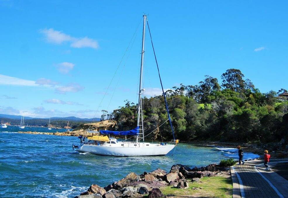 A small yacht broke loose from its moorings in Sunday's wild weather and nearly ran aground on the little beach near Thompson’s point.
It went up around 12 noon, and the water police were successful in getting it off (with a lot of help!) by around 3pm. PHOTOS: Julie Fourter.