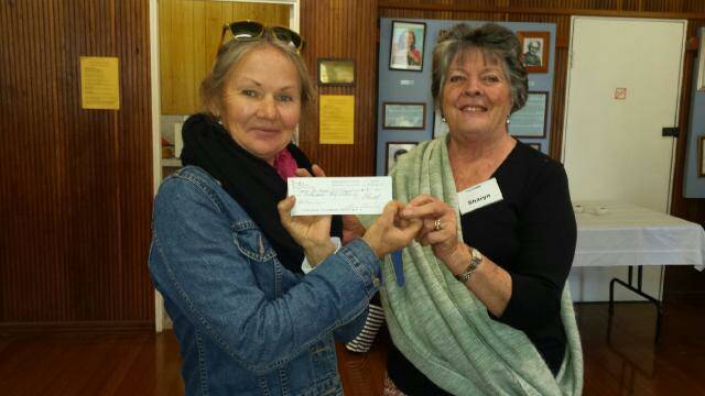Pebbles for Nepal: The Eden CWA’s president Sharyn Nemmensma, presenting a cheque to Jenny Stewart allowing her to purchase a water tank on behalf of the club.