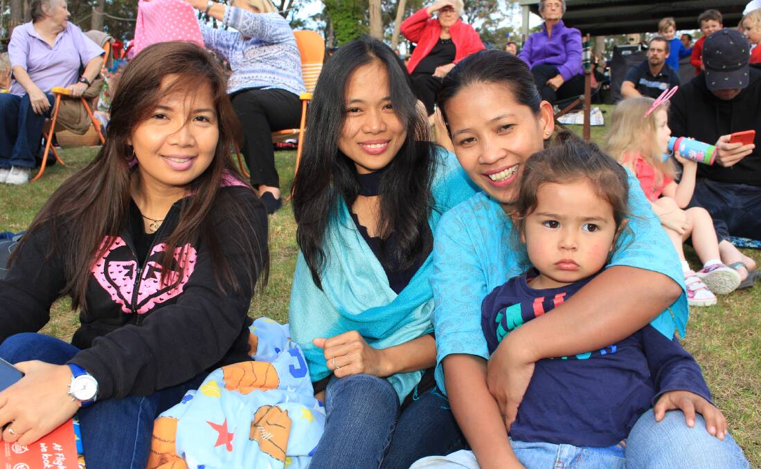 Eden's Leah Fantham, Lenie DelosReyes, Lhily Worthley and her daughter, Brandy, 2, at the Carols by Candlelight at Magic Mountain on Friday.