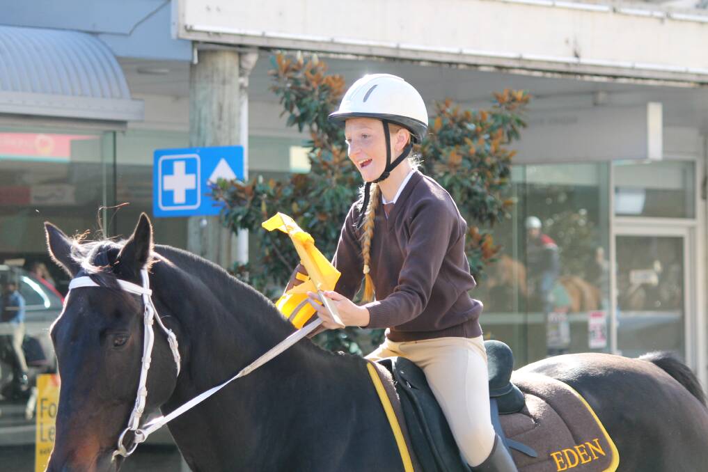 PARADING IN TOWN: Mackenzie Baker of Eden rides down the main street of Bega on Tuesday as part of the Bega Pony Club Camp. Picture: Albert McKnight