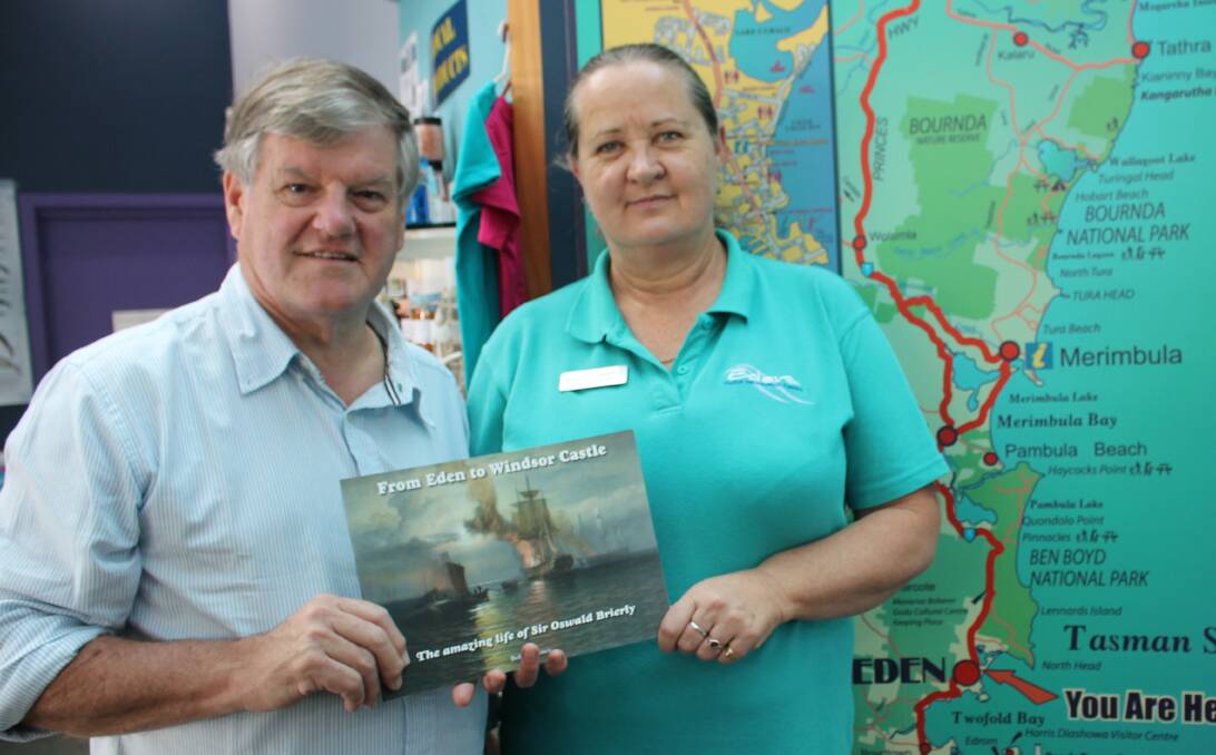 AUTHOR VISIT: Sydney author Bob Lawrence hands a copy of his book on the life of Sir Oswald Brierly to Eden Visitor Information Centre manager Deb Richardson. 