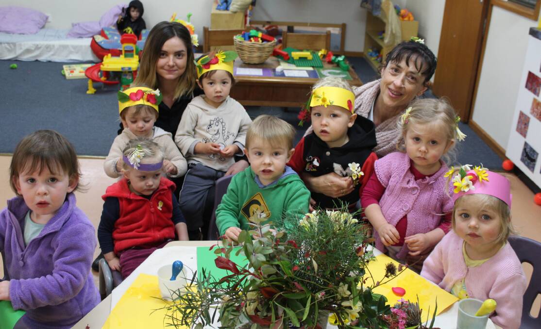 New season: The two to three year olds at Eden Child Care Centre make flower crowns with educators Catherine Brown and Jane Ganchov.  More photos online. 
