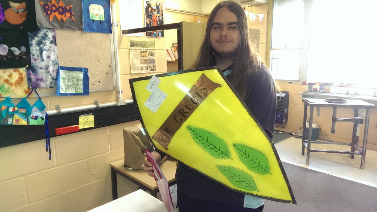 Metal work: Eden Marine High year 12 student Jayden Cleary with the family crest in the form of a metal shield he made for his final project. 