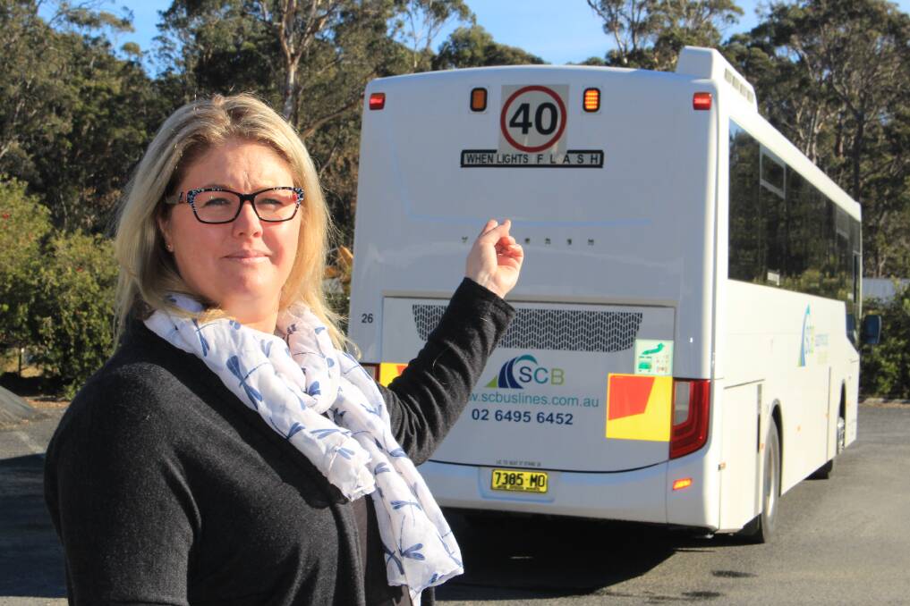 Safety first: Managing director of Sapphire Coast Buslines Jamie Klemm points to the flashing lights on the back of the bus.