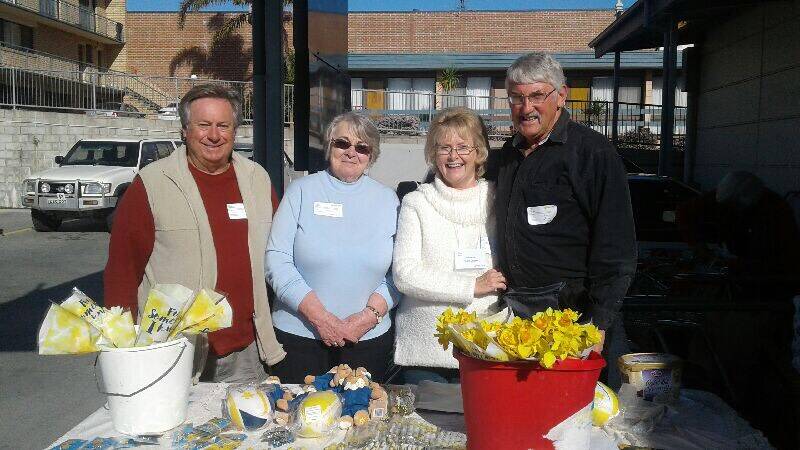For a good cause: Daffodil Day volunteers selling the much loved flowers along with other Cancer Council merchandise at the stall at Eden Coles on Friday, August 25. 