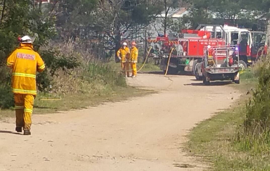 Grass fire: Local RFS volunteers work to put out a fire in Pambula on Saturday. 