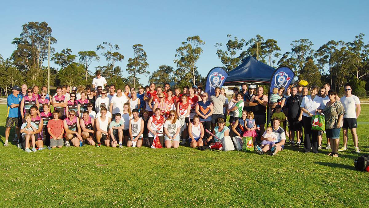 • Participants from last year’s fun footy at Pambula Beach gather to celebrate after a game. Organisers are hoping this year will be just as successful. 