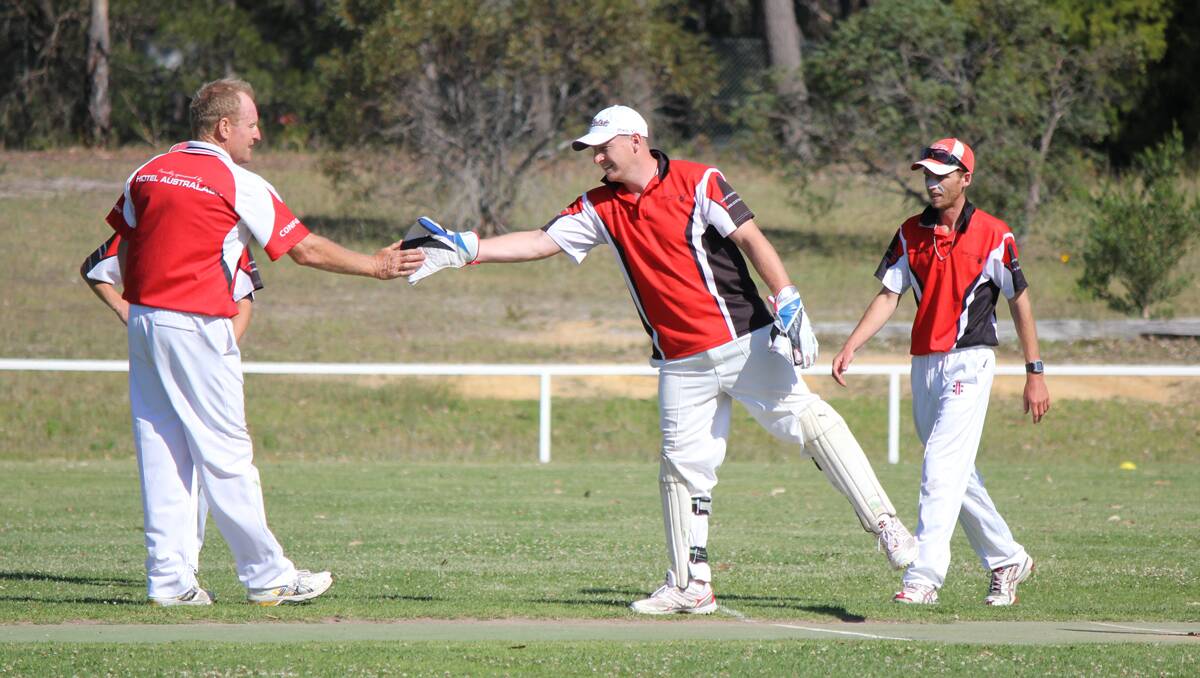• Neil Baker (left) gives Ian Smith a quick high five after a spectacular first catch against Tathra on Saturday. 