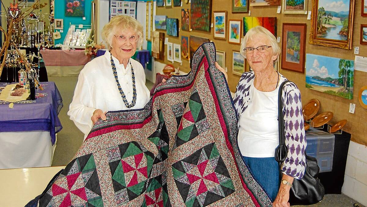 • Elaine Craker (left) and Enid Whiter proudly display Jenny’s quilt, which has raised approximately $750 for Nullica Lodge.