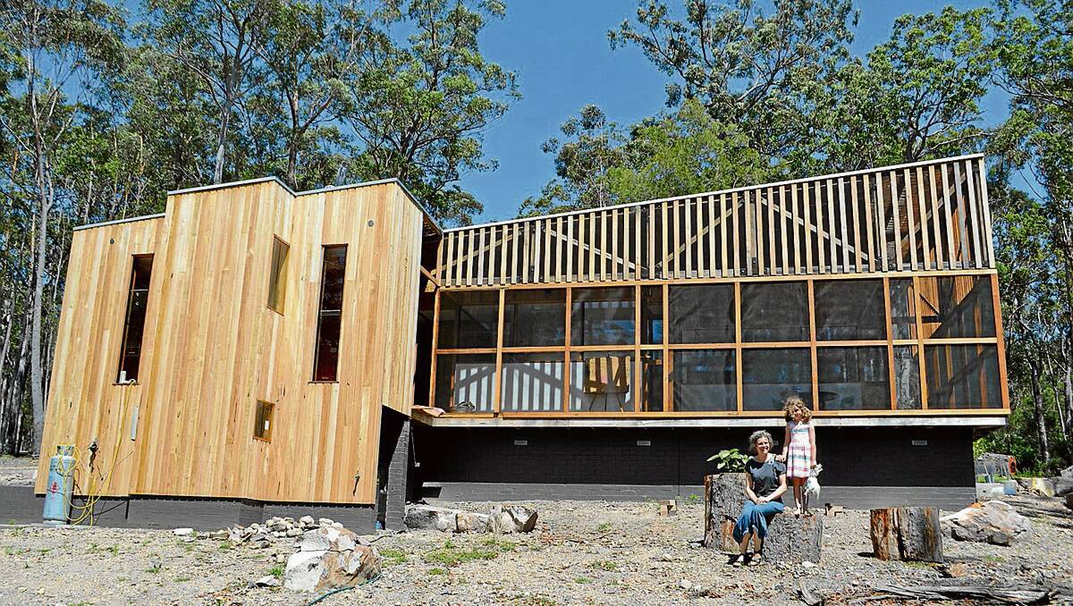 • Sunny Wilder and daughter Lyla enjoy their new home in Bald Hills. The flat pack house, erected in a weekend, was designed and built by Sunny and her partner Nick Coyle of The Timber Trip in Pambula.