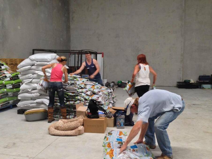 Volunteers sort feed and tack the Disaster Relief Centre at North Richmond on Wednesday morning.
