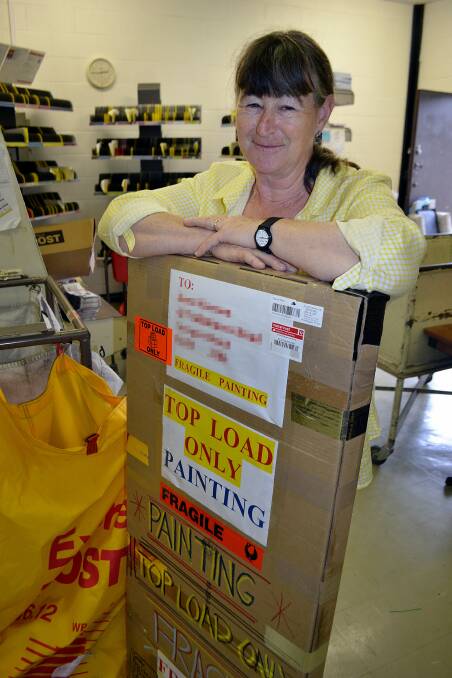 Postal services worker Helen Walder readies some parcels for Tuesday night's truck.