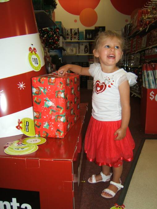 India-Rose Emmerson of Eden donates a present to the Uniting Care Christmas Appeal, Operation Santa. She is learning to be a gift giver and to think about the pleasure she can give to others. 